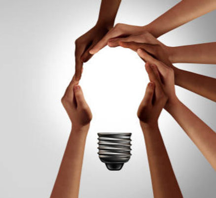 hands of people of different races arranged to look like light bulb